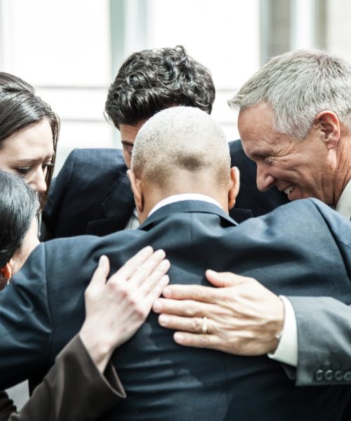 Mixed race group of business people in an informal team building meeting.